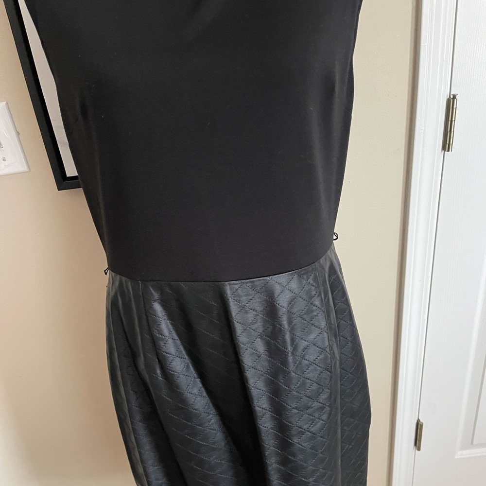 Black Calvin Klein dress with a leather bottom